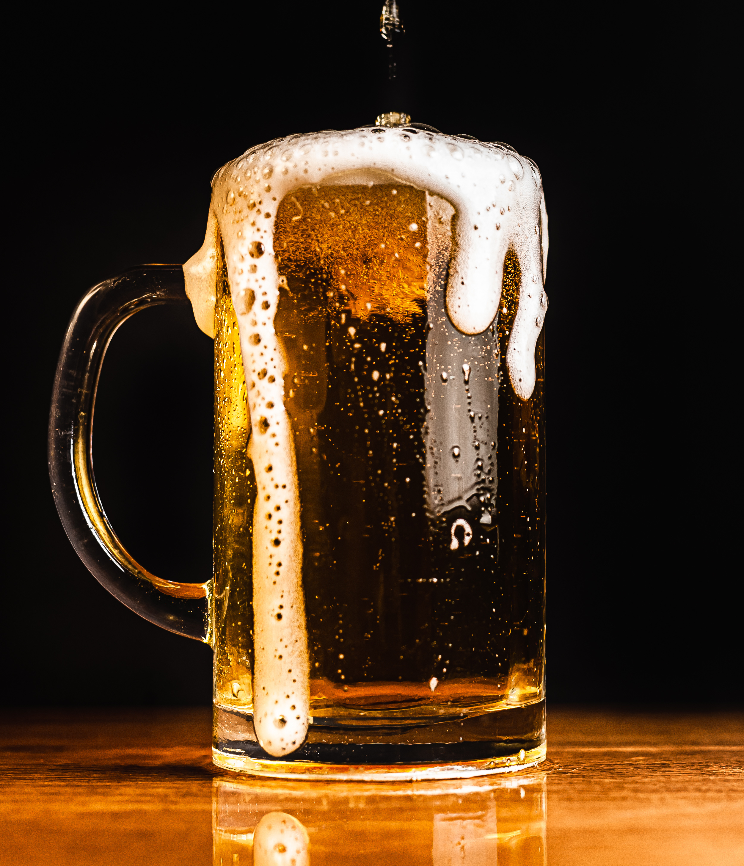 Bierglas mit Schaum, der überläuft
